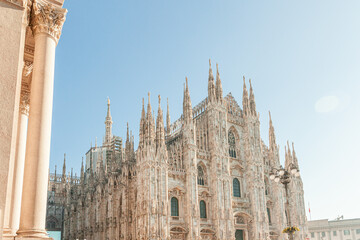 Famous church Milan Cathedral Duomo di Milano with Gothic spires and white marble statues. Top...