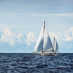 Old expensive vintage two-masted sailboat (yawl) close-up, sailing in an open sea. Coast of Maine, US. Sport, cruise, tourism, recreation, leisure activity, transportation, nautical vessel