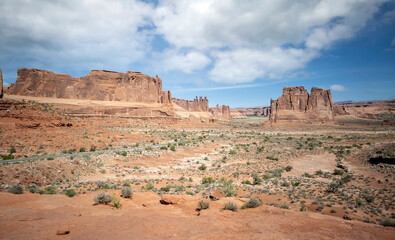 Fototapeta premium Dazzling Arches National Park in the summertime with sandstone formations on a partly cloudy day in Utah