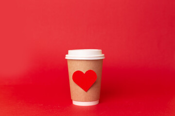 paper cup with red hearts on a red background. valentine's day romantic takeaway coffee concept. love of coffee and travel