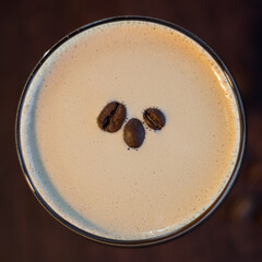 Espresso Martini cocktail drink beverage with coffee beans on a wooden table