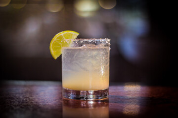 Margarita cocktail drink beverage with lemon slice and bokeh background