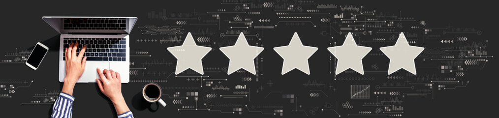 Rating star concept with person using a laptop computer