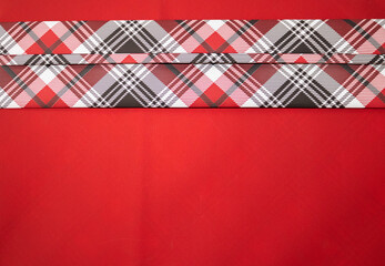 Fototapeta premium Horizontal plaid red and black stripe on a red background
