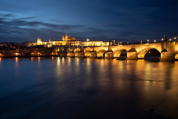 .panoramic view of Charles Bridge on the Vltava river and in the background Prague Castle and St. Vitus Cathedral in the center of Prague in the evening