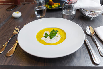 Beautiful professional close up of a gourmet soup with cream and herbs. Expensive looking...