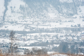 Fototapeta na wymiar Misty winter morning in mountain village