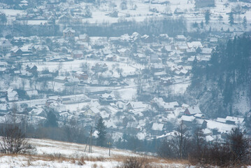 Fototapeta na wymiar Misty winter morning in mountain village