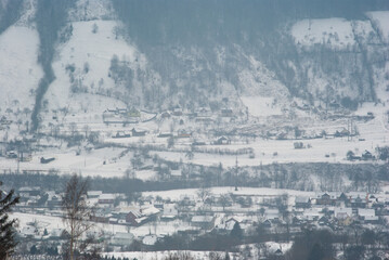 Misty winter morning in mountain village