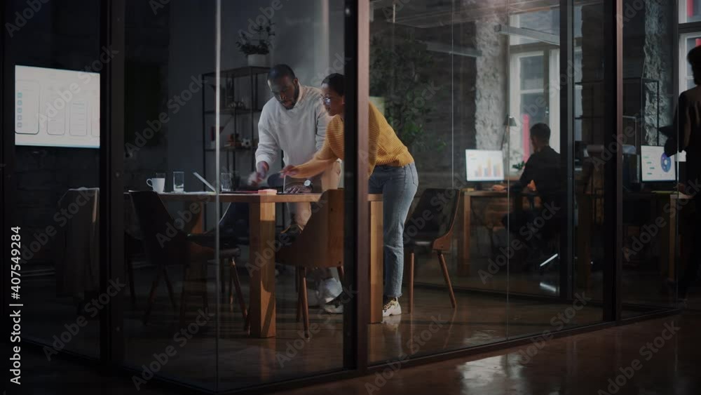 Poster two diverse multiethnic colleagues have a conversation in a meeting room behind glass walls in an ag