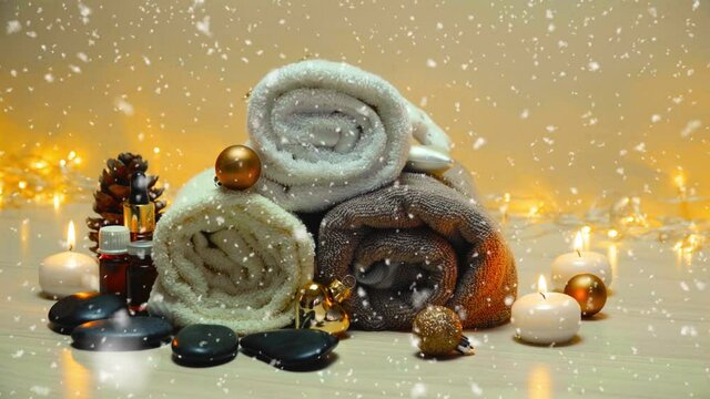 Spa salon items and attributes with christmas decorations in mild snowfall, beautiful christmas landscape with spa elements 4K