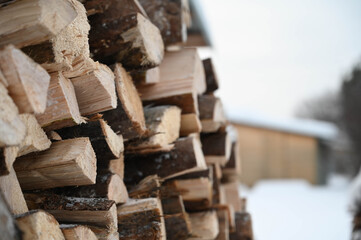 Close-up of firewood in wooden pile at winter.