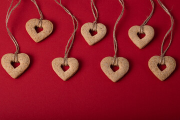 Valentine's day cookies on red background. Ginger biscuits in the shape of heart