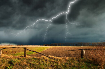 lightning over the meadow. stormy sky over rural landscape