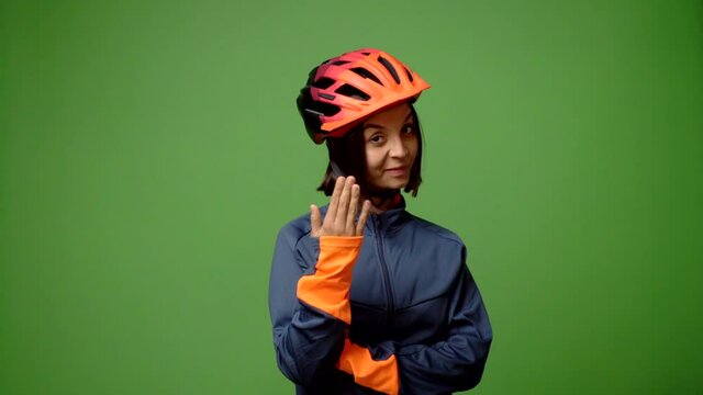 Young woman with cycling helmet presenting and inviting to come with hand
