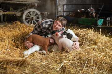 Cinematic shot of young happy proud male farmer is embracing with love and care ecologically grown...