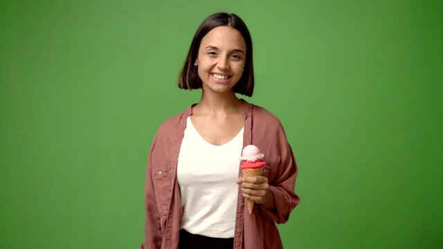 Young woman holding a cornet ice cream shouting and announcing something
