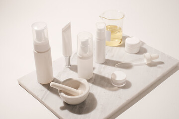 cosmetic and skin care for beauty routine on white background with shadow. modern and minimal product design with essential oil, pestle and mortar.