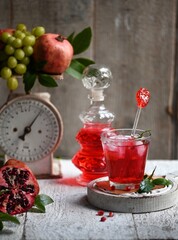  Pomegranate juice and pomegranate fruit on the wooden table.