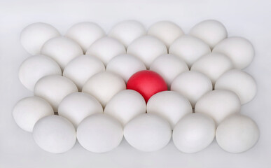 White boiled eggs and one red egg