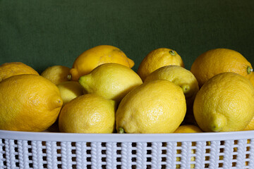 Organic fresh juicy lemons in a white bucket