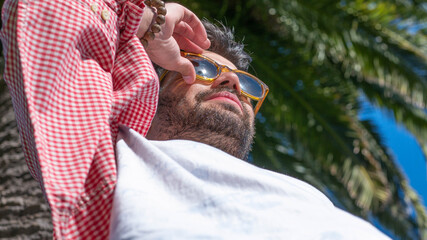 Young man touching his glasses