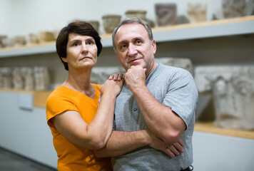 Portrait of american couple who is looking at the exposition in historical museum..