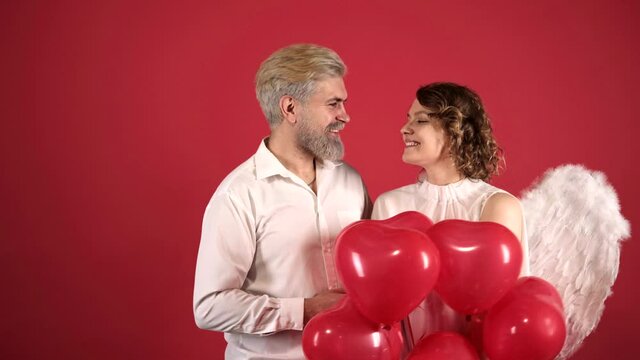 Valentines couple in love. Angel woman. Isolated on red.