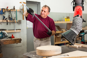 Master measures the wooden workpiece before machining. High quality photo