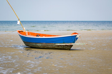 Image of small boat sitting on the beach.