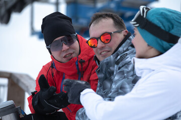 Group Of Friends Enjoying Hot Mulled Wine In Cafe At Ski Resort