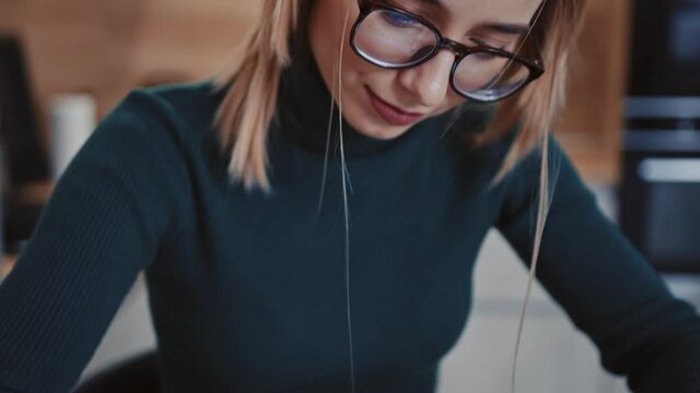 Close up young woman drawing at tablet computer creating illustration indoors at home. Sitting near desk. Workplace freelance business hobby freelancer talented. Slow motion