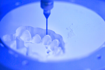 Dental milling machine carving out shape of human teeth