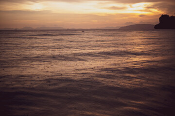 Thailand sunset over bay while raining