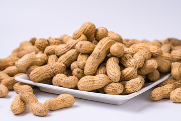 Peanuts with shells on white background