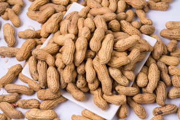 Peanuts with shells on white background