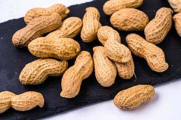 Peanuts placed on a black plate