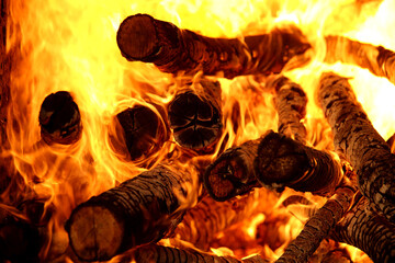 Burning firewood of red yellow and orange flames of the fireplace is very hot