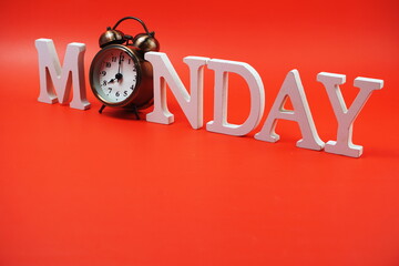 Monday alphabet letter with alarm clock on red background