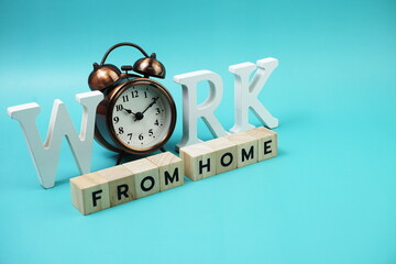 Work from Home alphabet letters with alarm clock on blue background