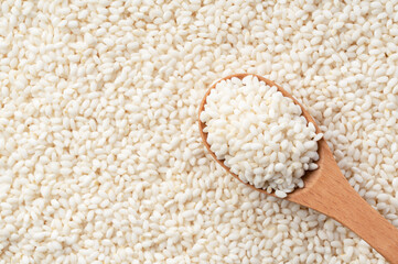 Wooden spoon on top of glutinous rice spread over the entire screen