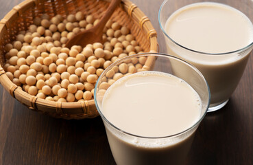 Soy milk in a glass on a wooden background