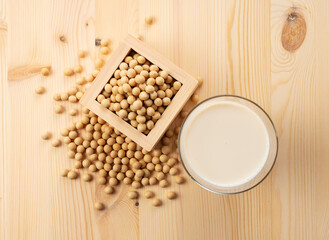 Soy milk in a glass on a wooden background