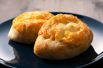 Cheese French bread placed in the background on a wooden table