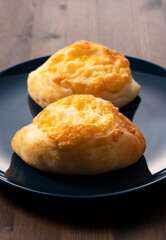Cheese French bread placed in the background on a wooden table