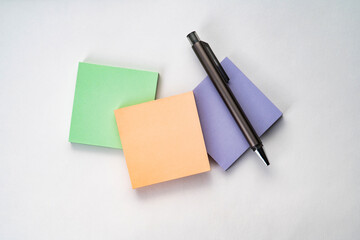 Top view of sticky note and pen with white isolated background 