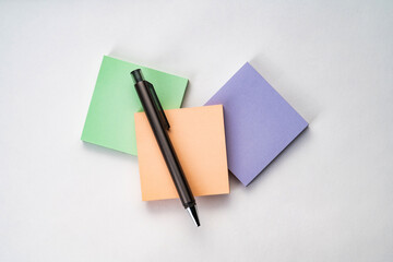 Top view of sticky note and pen with white isolated background 