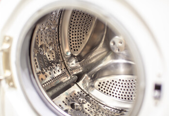 The washing machine drum is dry and clean close-up. Washer