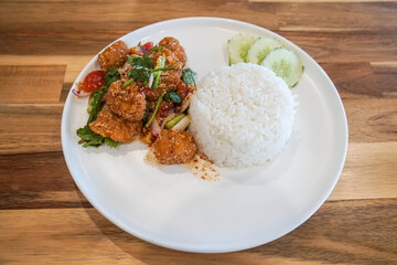 Jasmine rice with spicy chicken deep fried on white plate for quick lunch