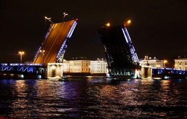 Fototapeta na wymiar Saint Petersburg. Russia. Panoramic view. The Palace bridge is divorced. Raising of the bridges. Bridges Of Petersburg. View from the Neva to the Hermitage. Winter palace in the evening. Panorama of